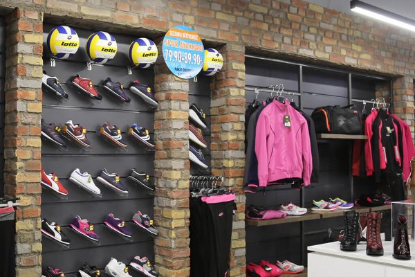 Heritage Faux Brick Wall Panel Painted Mix M269 Mixed colour brick wall of muted reds, yellows and greys in a sportswear shop